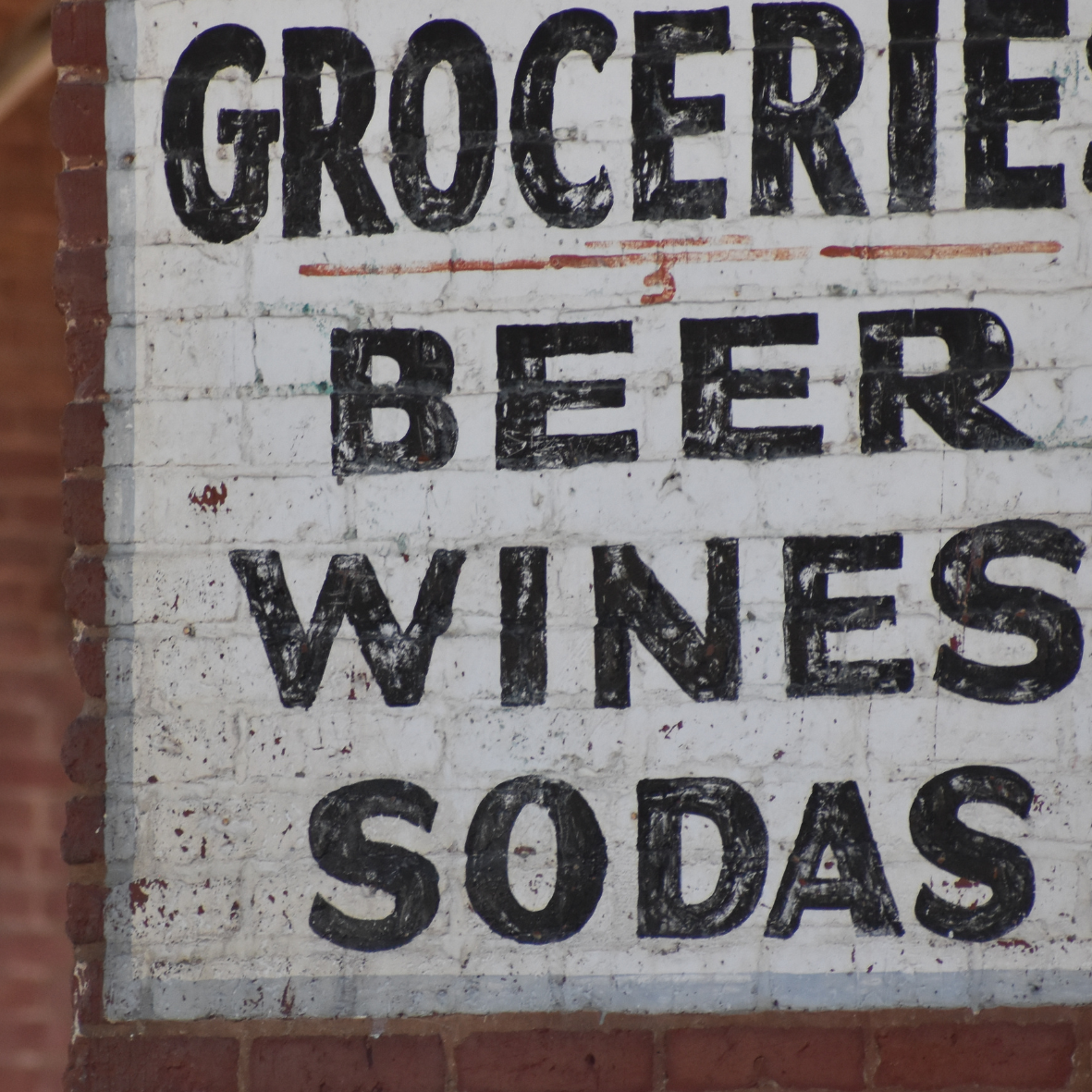 Sign in town says groceries beer wines sodas